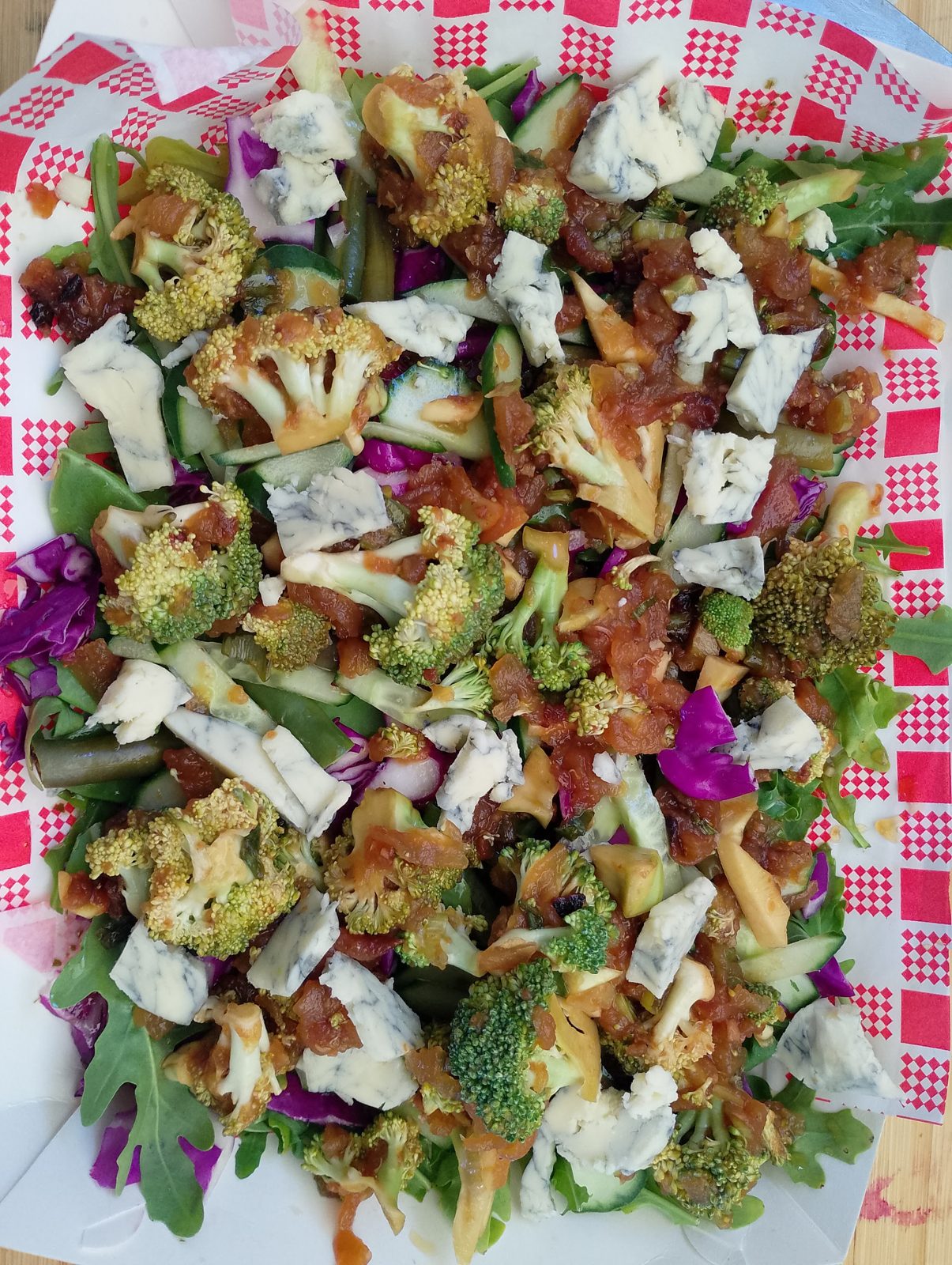 A big salad of broccoli, rocket, cucumber, red cabbage and blue cheese